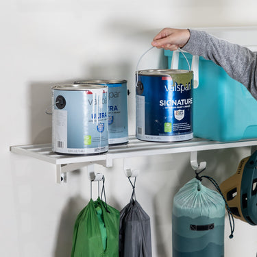 Two white Bristol wall-mounted garage shelves, 1 foot by 4 feet, sturdy and ideal for organized storage in a garage.