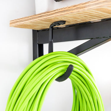 Heavy-duty StoreYourBoard wall-mounted shelf brackets for garage walls, supporting 1-foot by 4-foot DIY garage shelves.