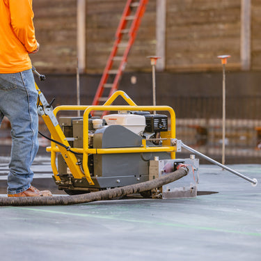 10-inch green concrete saw by Tomahawk Power with a 13 HP Honda GX390 engine, featuring a sturdy metal frame and cutting blade.